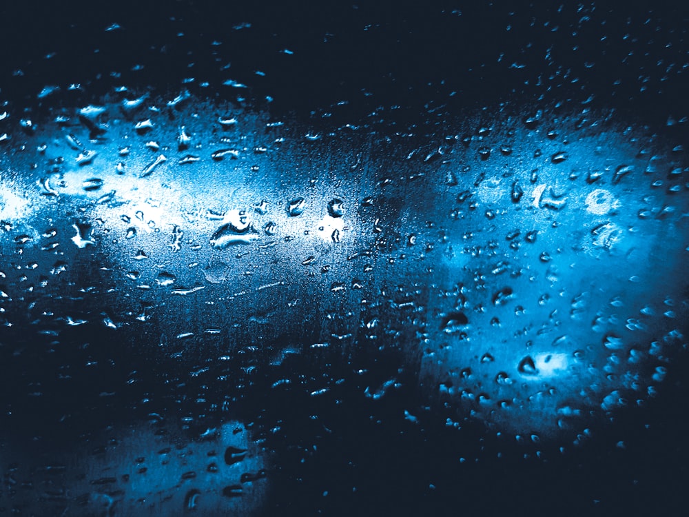 a close up of a window with raindrops on it