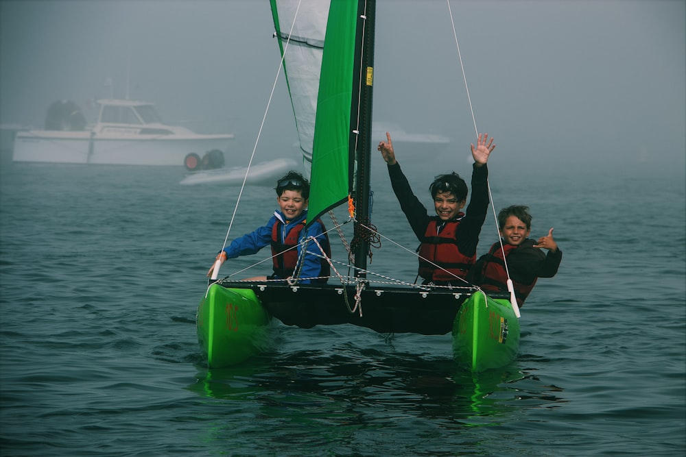 three people riding on boat