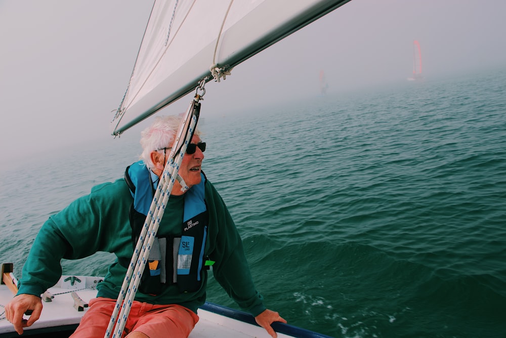 man sitting on boat during daytime