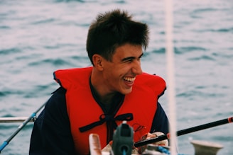 Close-up of a smiling customer wearing a helmet and life jacket after rafting.
