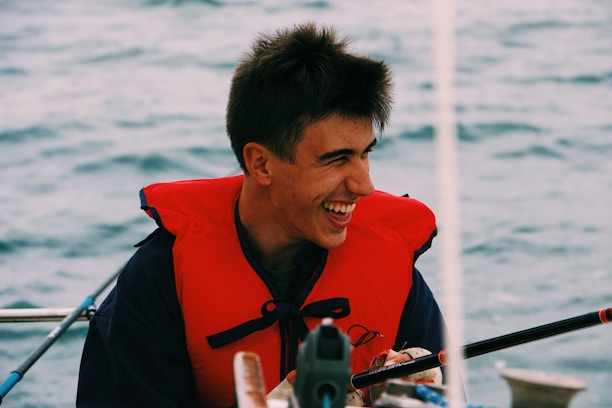 Close-up of a smiling customer wearing a helmet and life jacket after rafting.