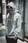 man standing near grey wlal