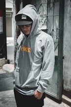 man standing near grey wlal