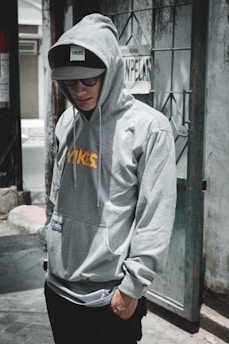 man standing near grey wlal