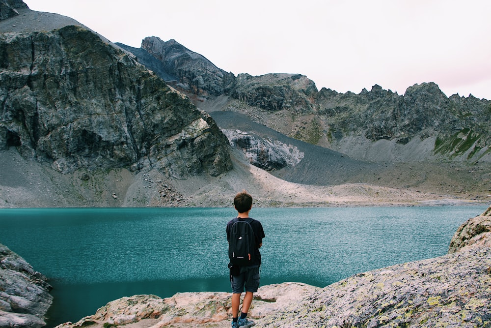 man standing in front of body of water