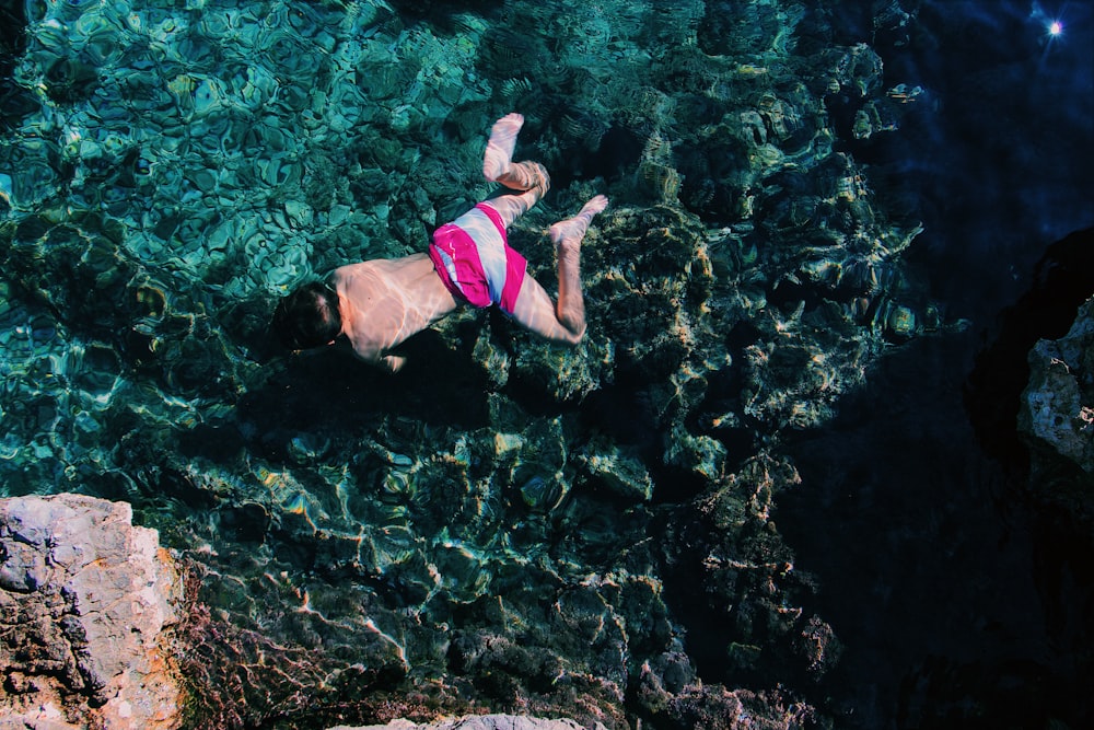 men swimming during daytime