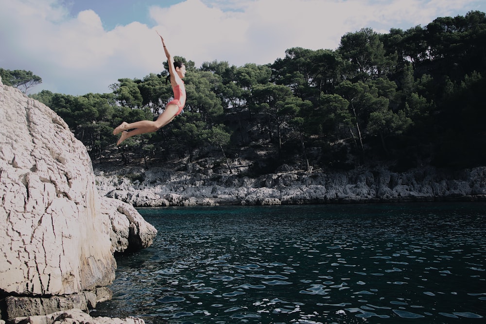 woman about to dive on body of water