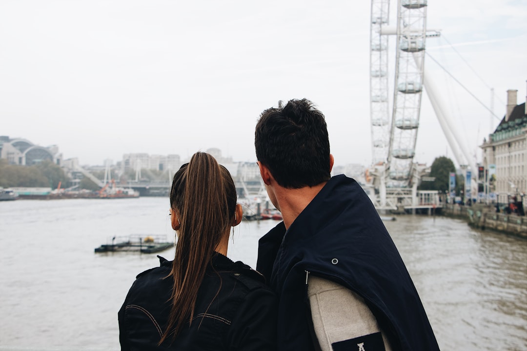 man and woman looking at sea