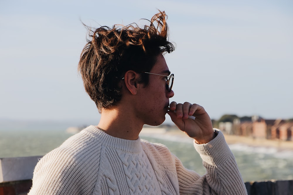 man wearing white cable-knitted top