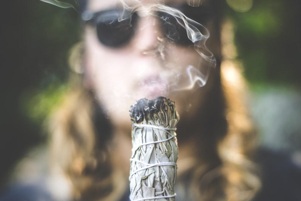 person holding white incense