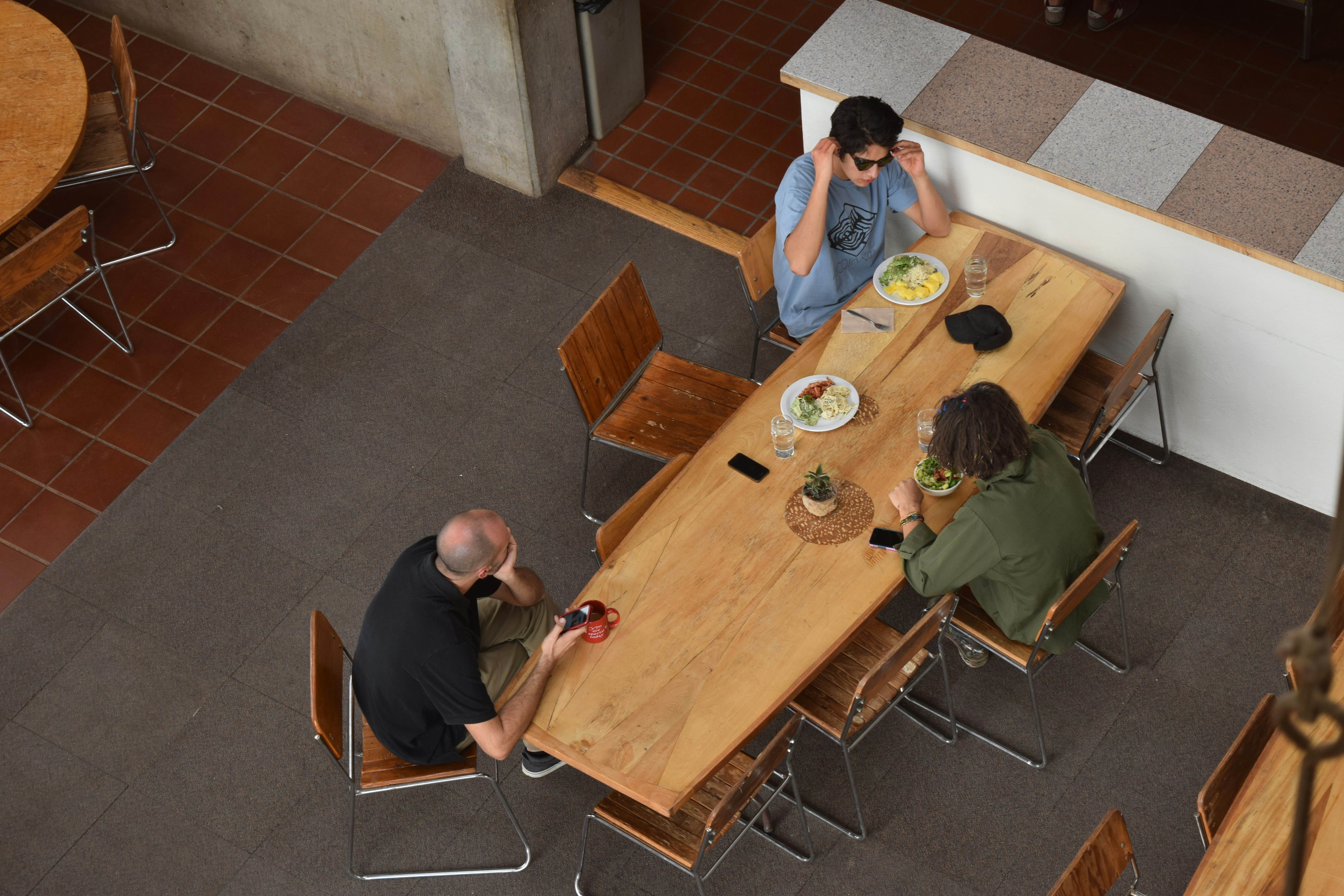 Three people sitting at table in aerial shot photo – Free Table Image ...