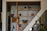 Friendly handyman fixing a wooden shelf in a cozy living room.
