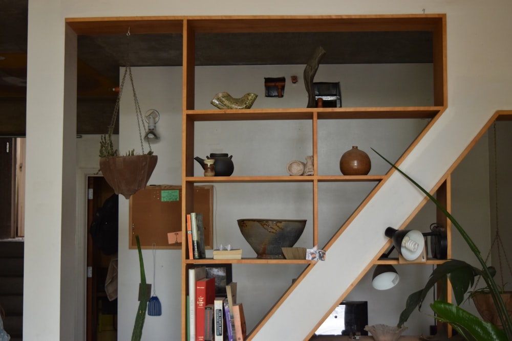 vases on brown wooden shelf