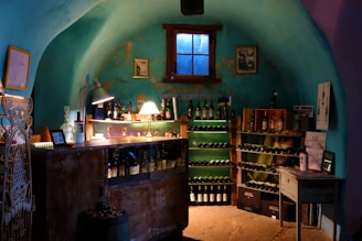 A cozy wine cellar featuring rich oak racks and warm glowing lights highlighting each bottle.