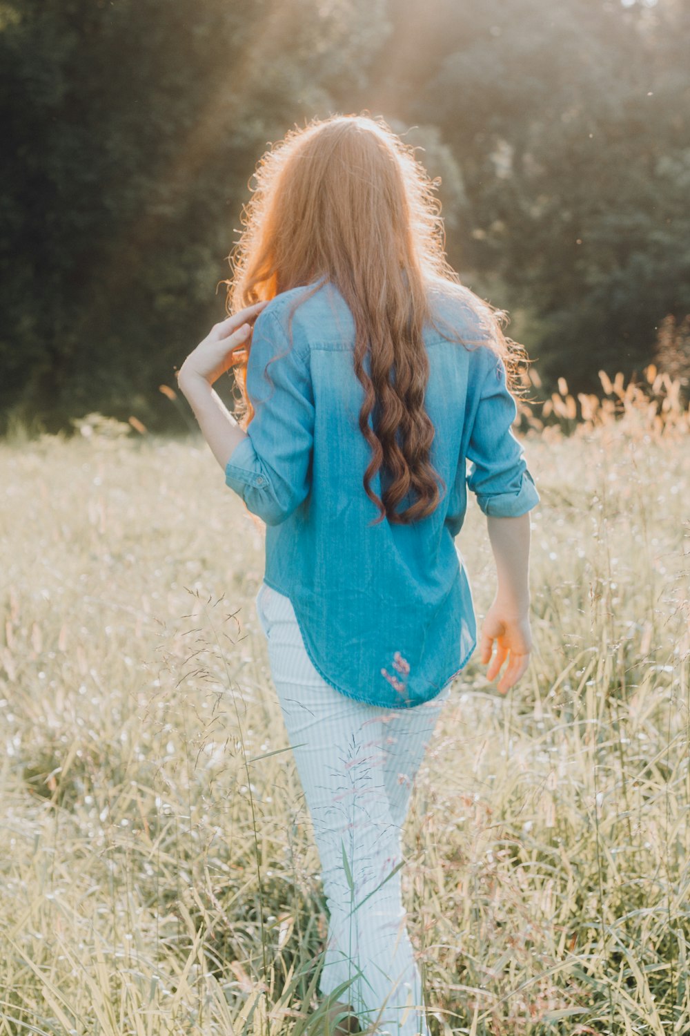 woman walking on grass field