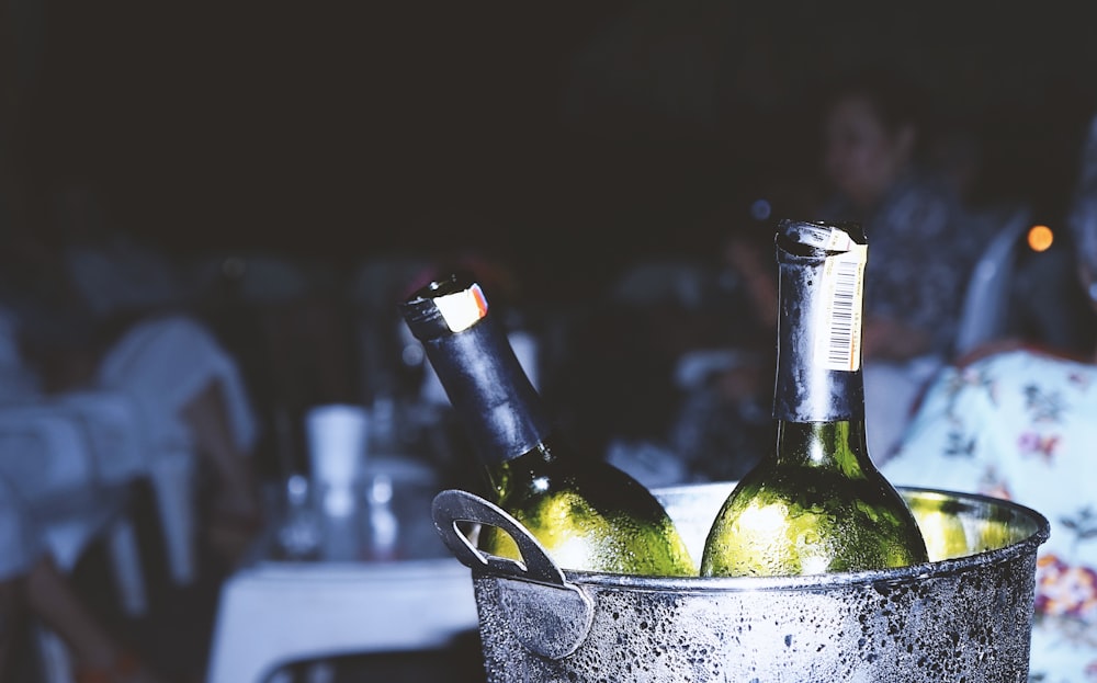 two liquor bottles in bucket