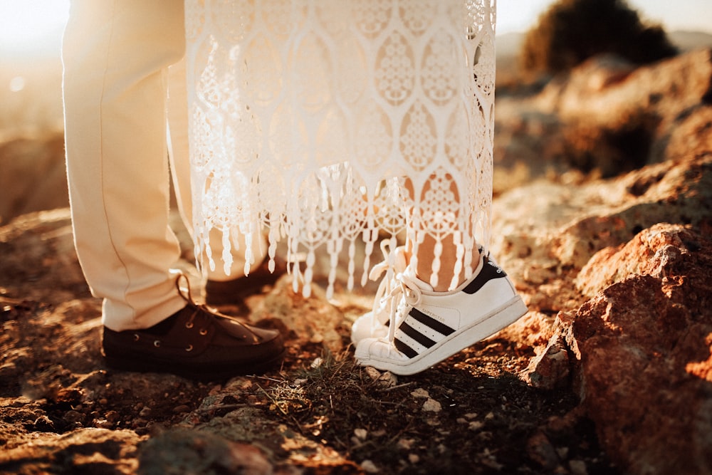 man and woman standing on ground during golden hour