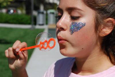 Child laughing while blowing bubbles