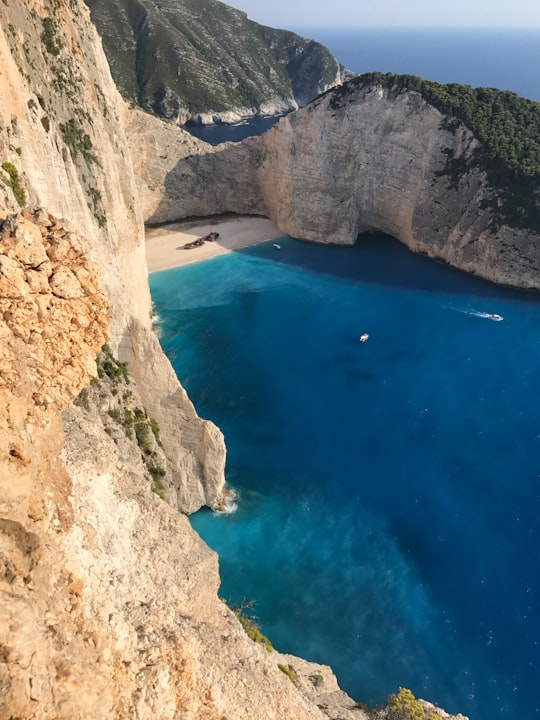 rock formation near body of water in Shipwreck Beach Greece