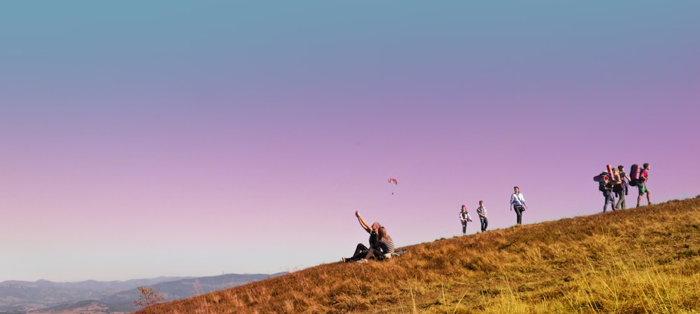 people on hill during daytime