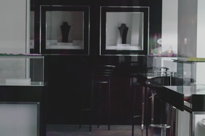 A sleek, dimly lit vault interior showcasing custom compartments for watches, jewelry, and couture garments.