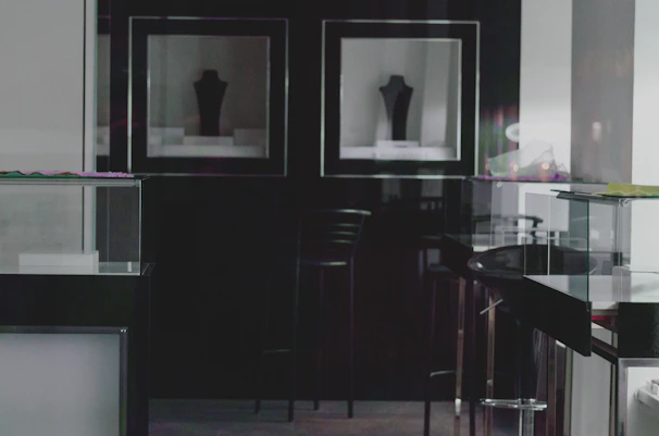 A sleek, minimalist display of modern fashion pieces arranged on a monochrome backdrop with subtle blue accents.