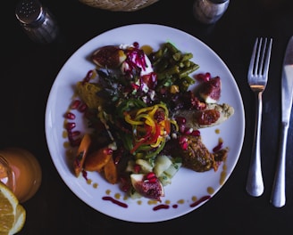 cooked food on white ceramic plate beside fork