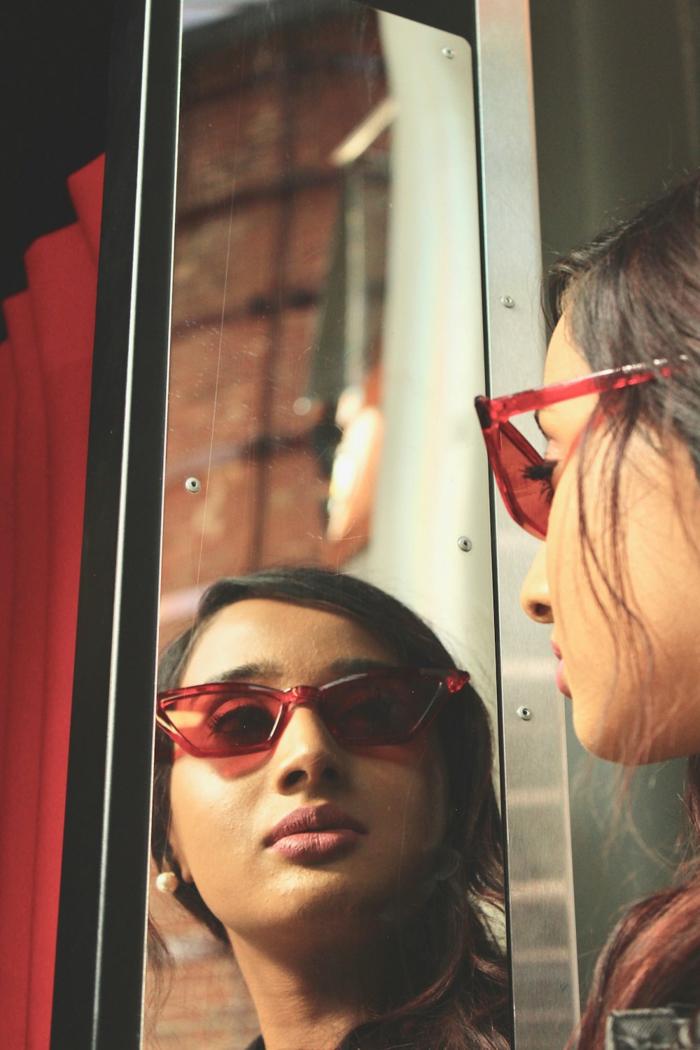 woman facing her reflection on mirror