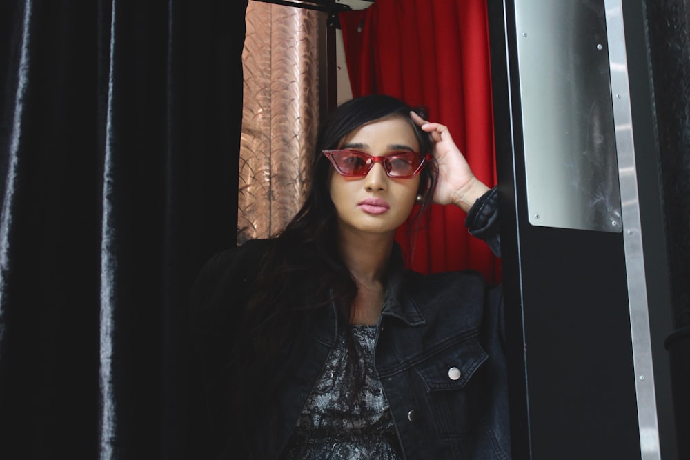 woman wearing red framed sunglasses