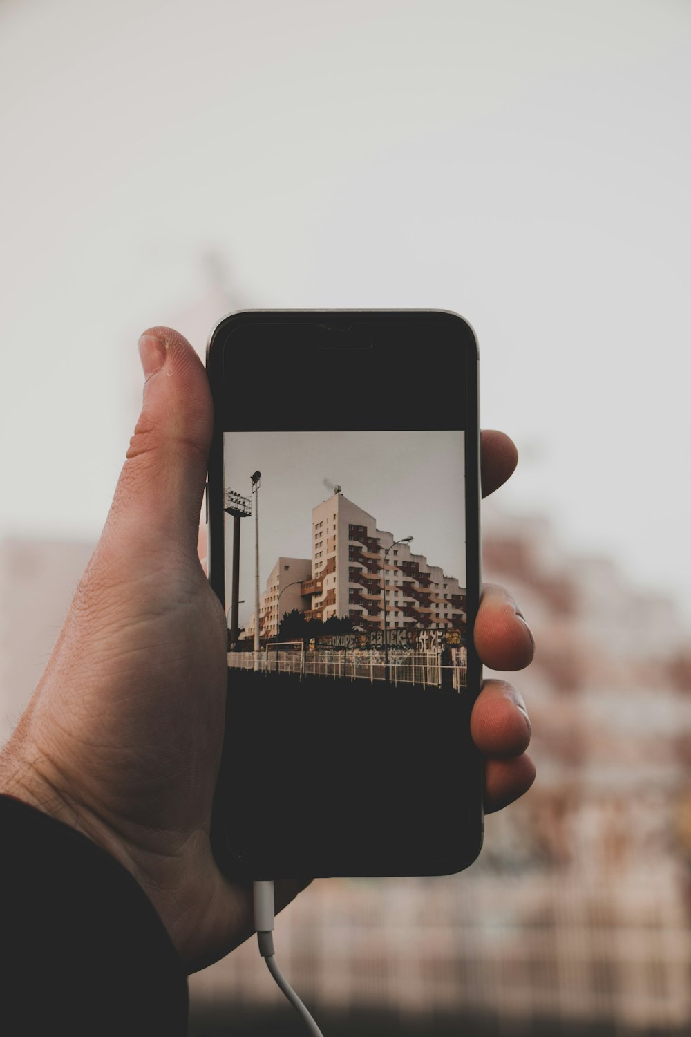 person taking white building