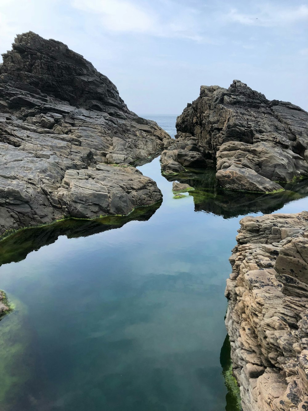 three gray stones on sea side