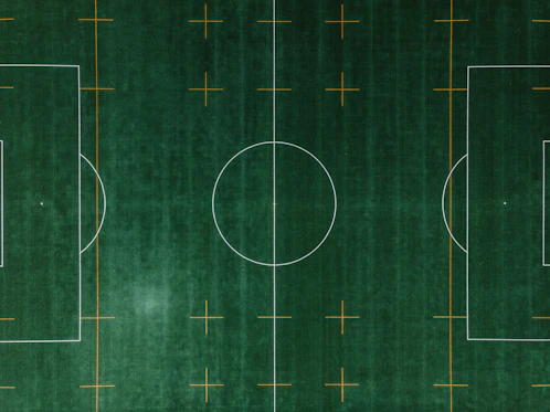 Icon of a soccer field with tactical markings and player positions.