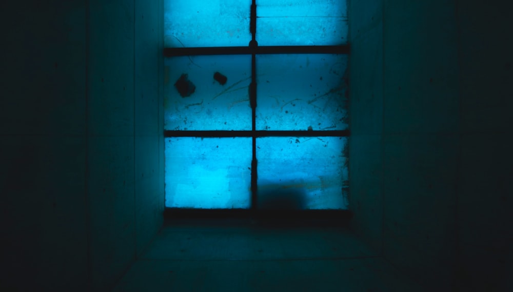 a window with a blue light shining through it