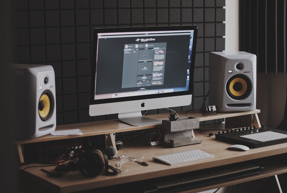 silver iMac turned on at the table