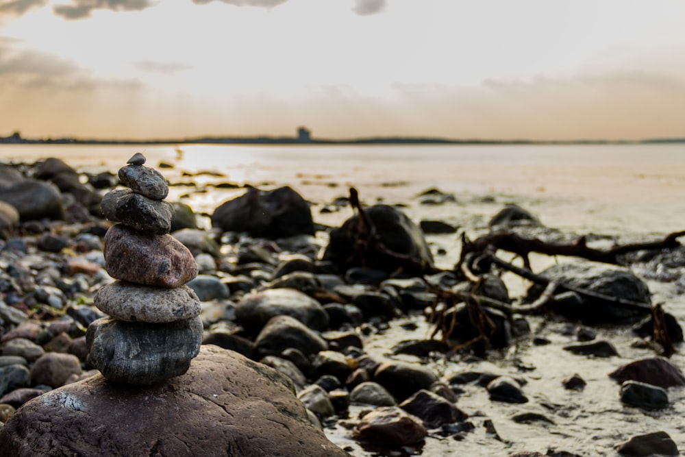 stone formation near body of water during daytime