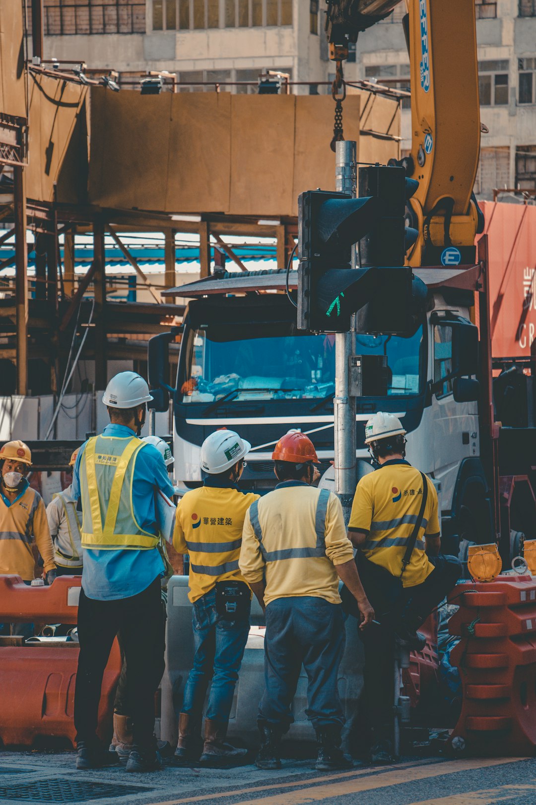 four men standing near construction truck