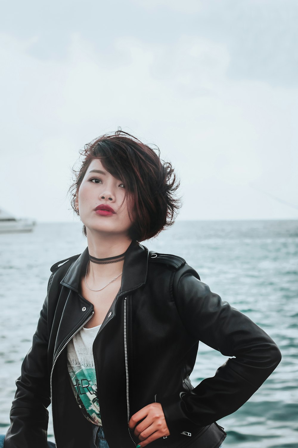 woman in black blazer near body of water