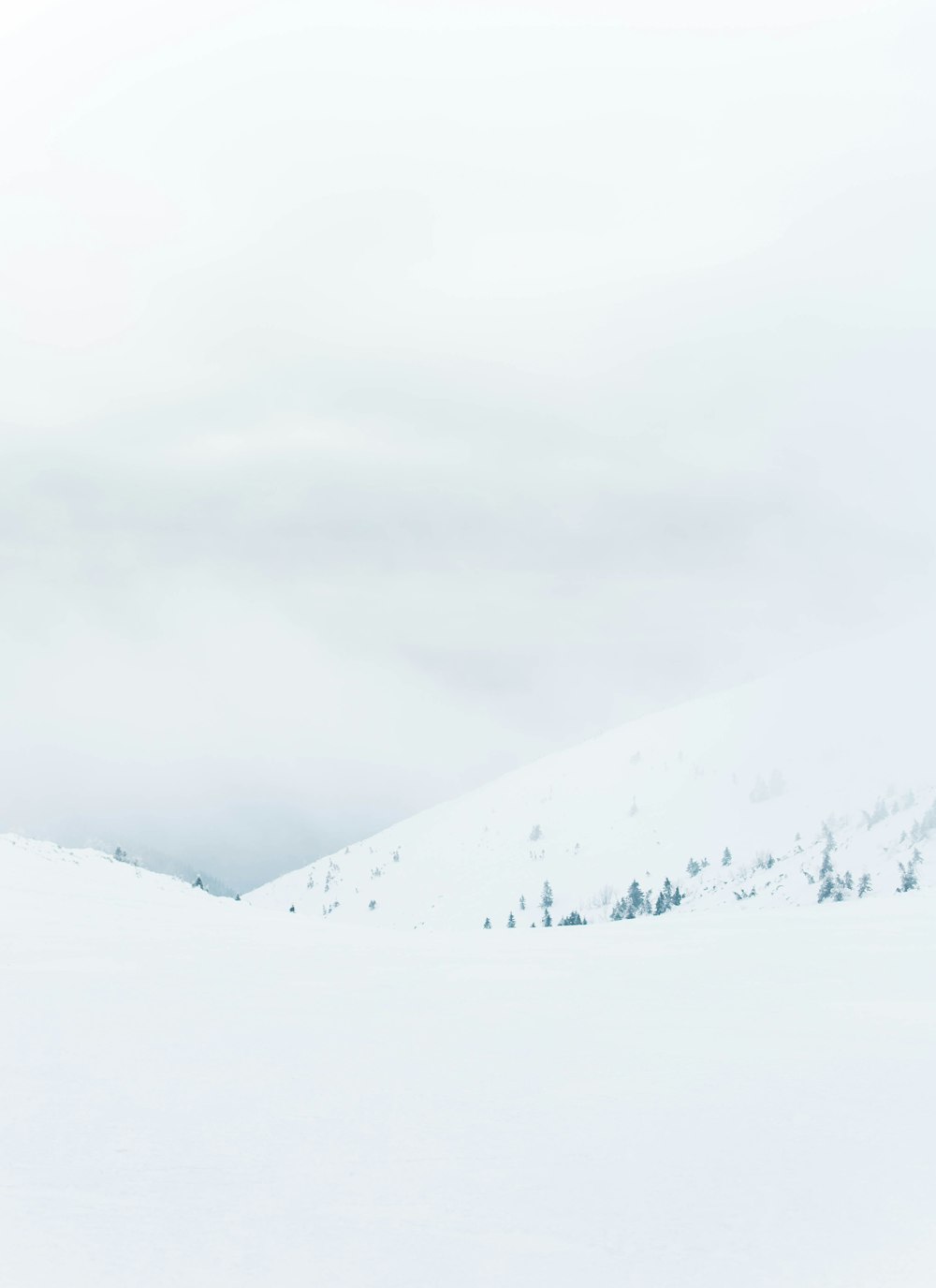 a man riding skis down a snow covered slope