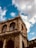 A historic building standing under a bright blue sky, symbolizing preservation and heritage.