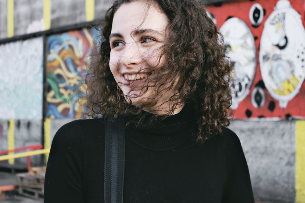 woman wearing black cowl-neck shirt