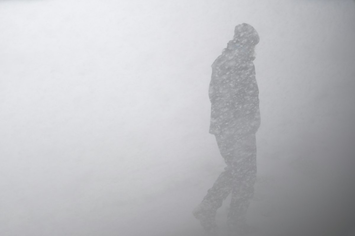 Snowstorm blowing across frozen terrain