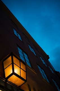 Evening view of a finished residential building illuminated warmly, highlighting detailed craftsmanship