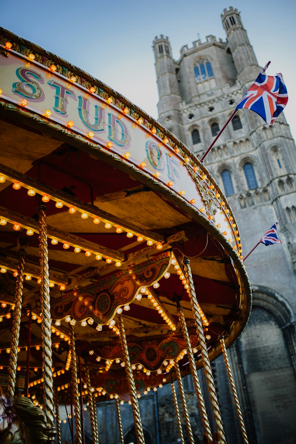 British flag flying over circus carousel