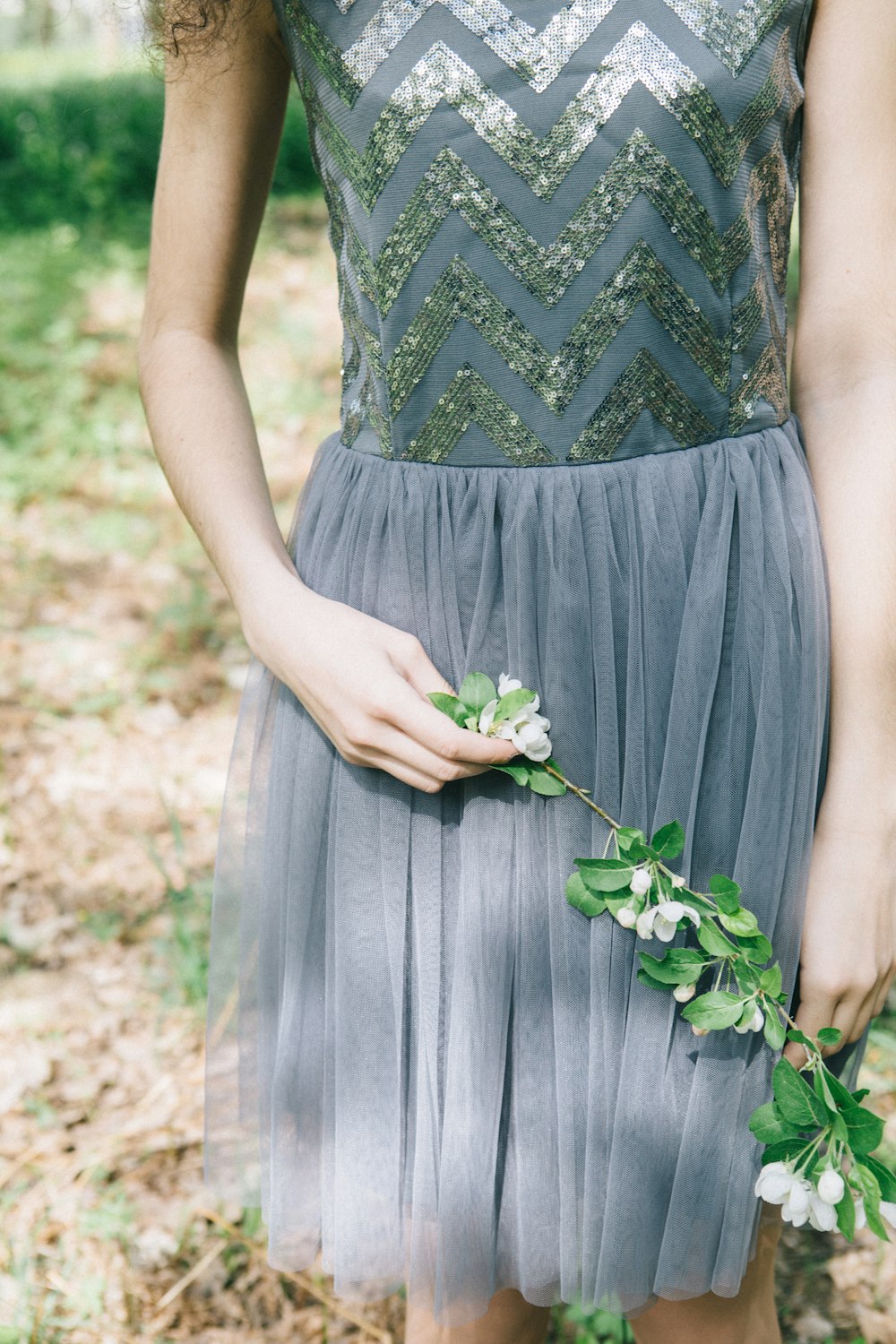 woman standing while holding flower