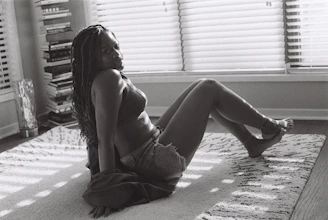 A serene portrait of Charles Blevins sitting peacefully in a sunlit room filled with books and spiritual artifacts.