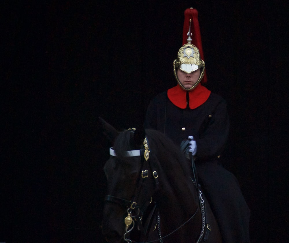 man riding on black horse