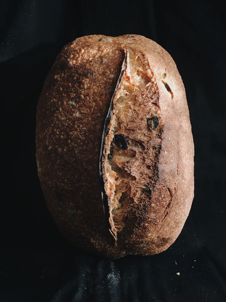 A dark-crusted country loaf split open along its score