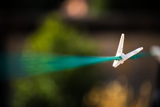 a toy airplane is flying through the air