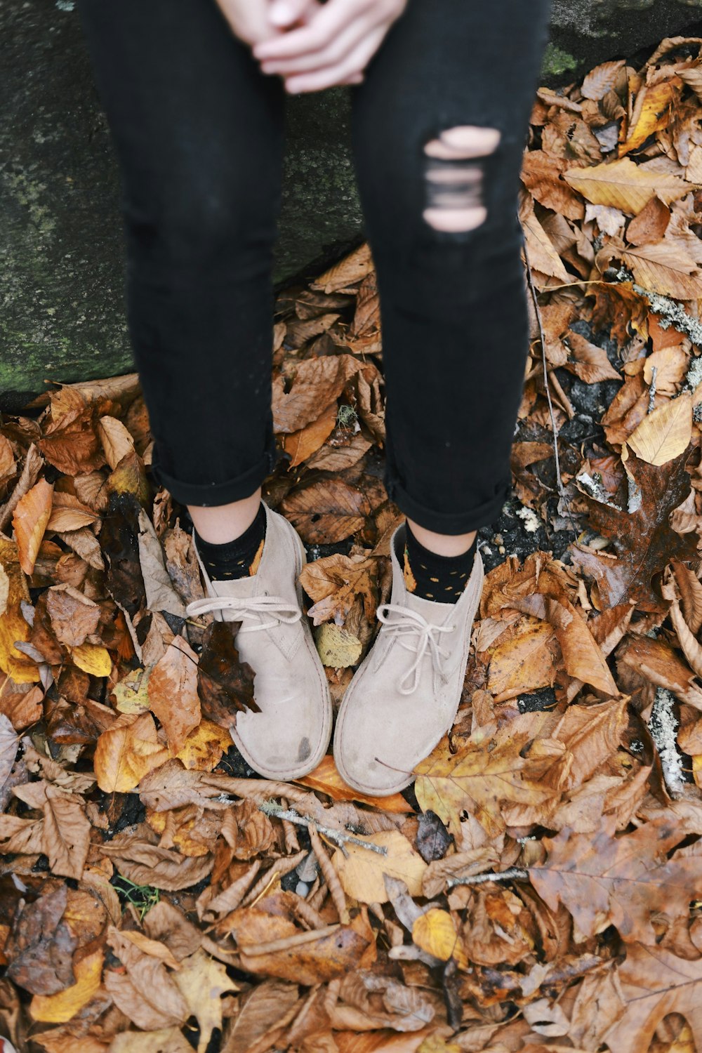 a person standing in a pile of leaves