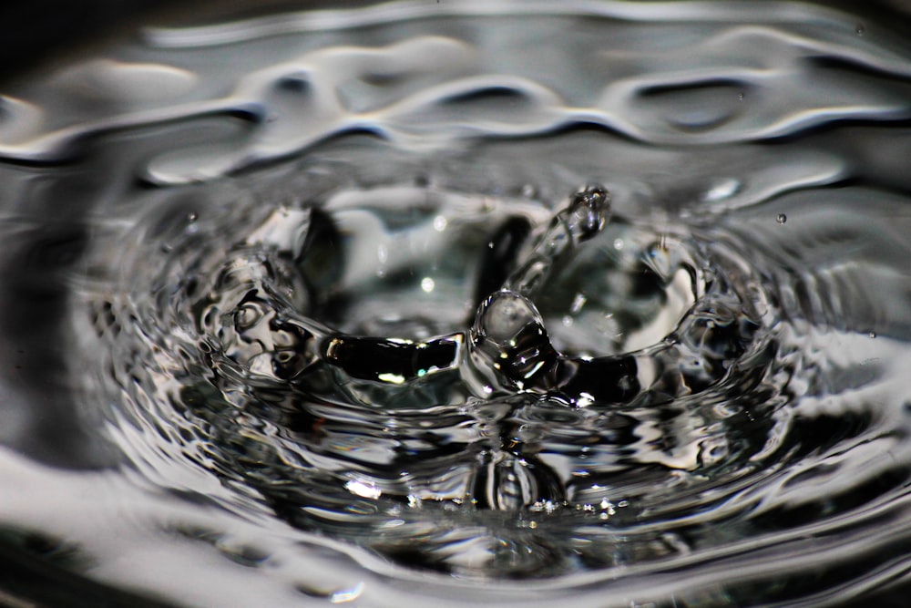 a close up of a water drop with a black background